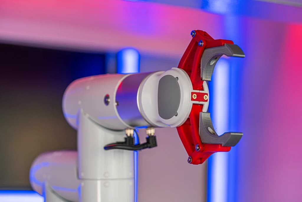 Robotic arm close-up with magenta and blue lighting